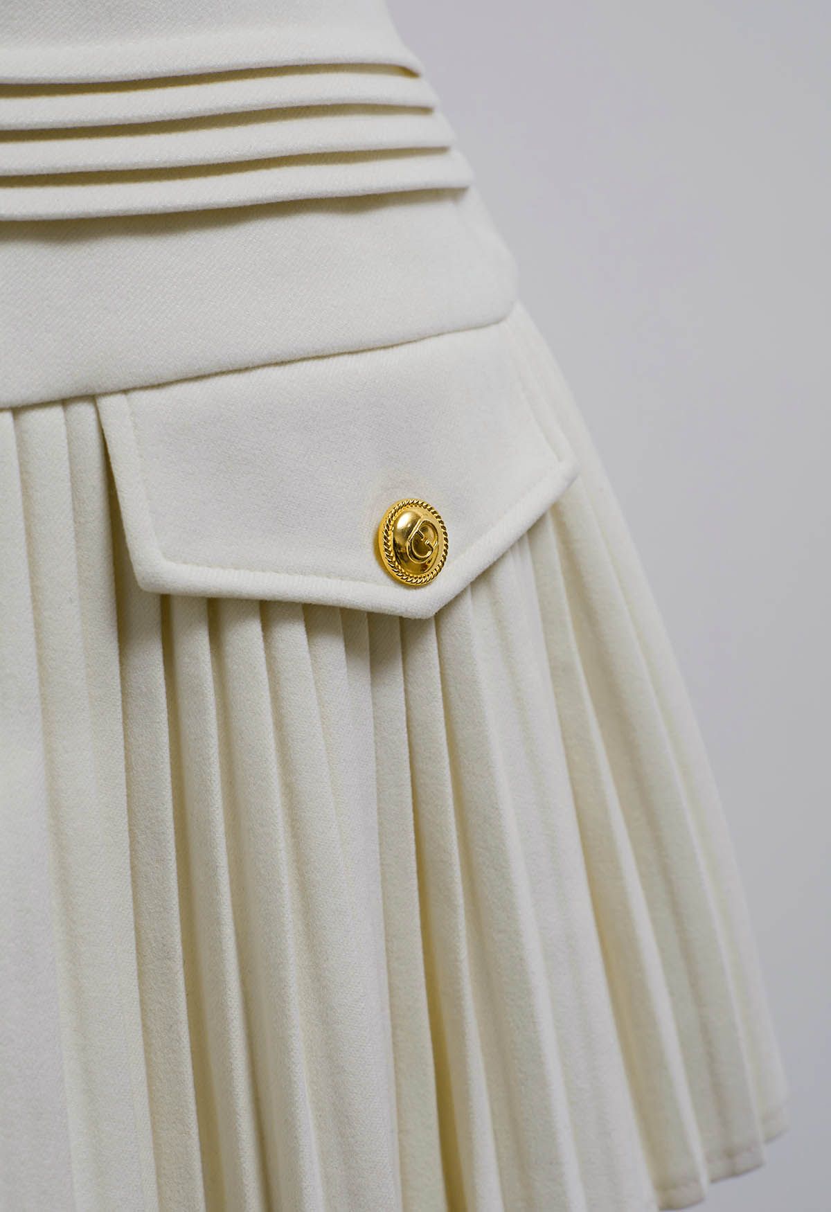 Golden Button Decorated Pleated Mini Skirt in Ivory